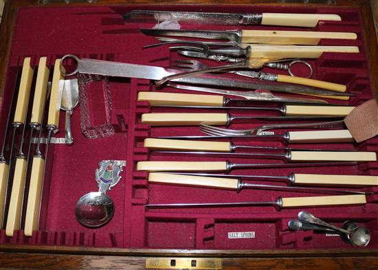 A part canteen of plated cutlery and other plated flatware housed in an oak canteen with brass handles.